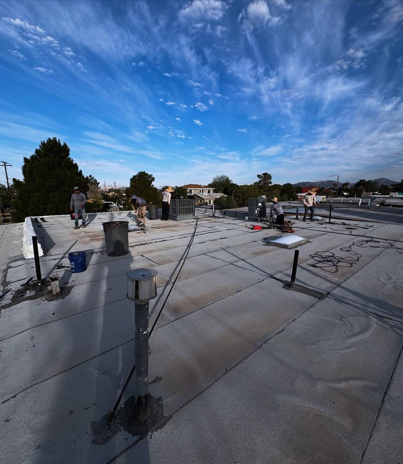 Flat roof membrane work in progress on a commercial roof