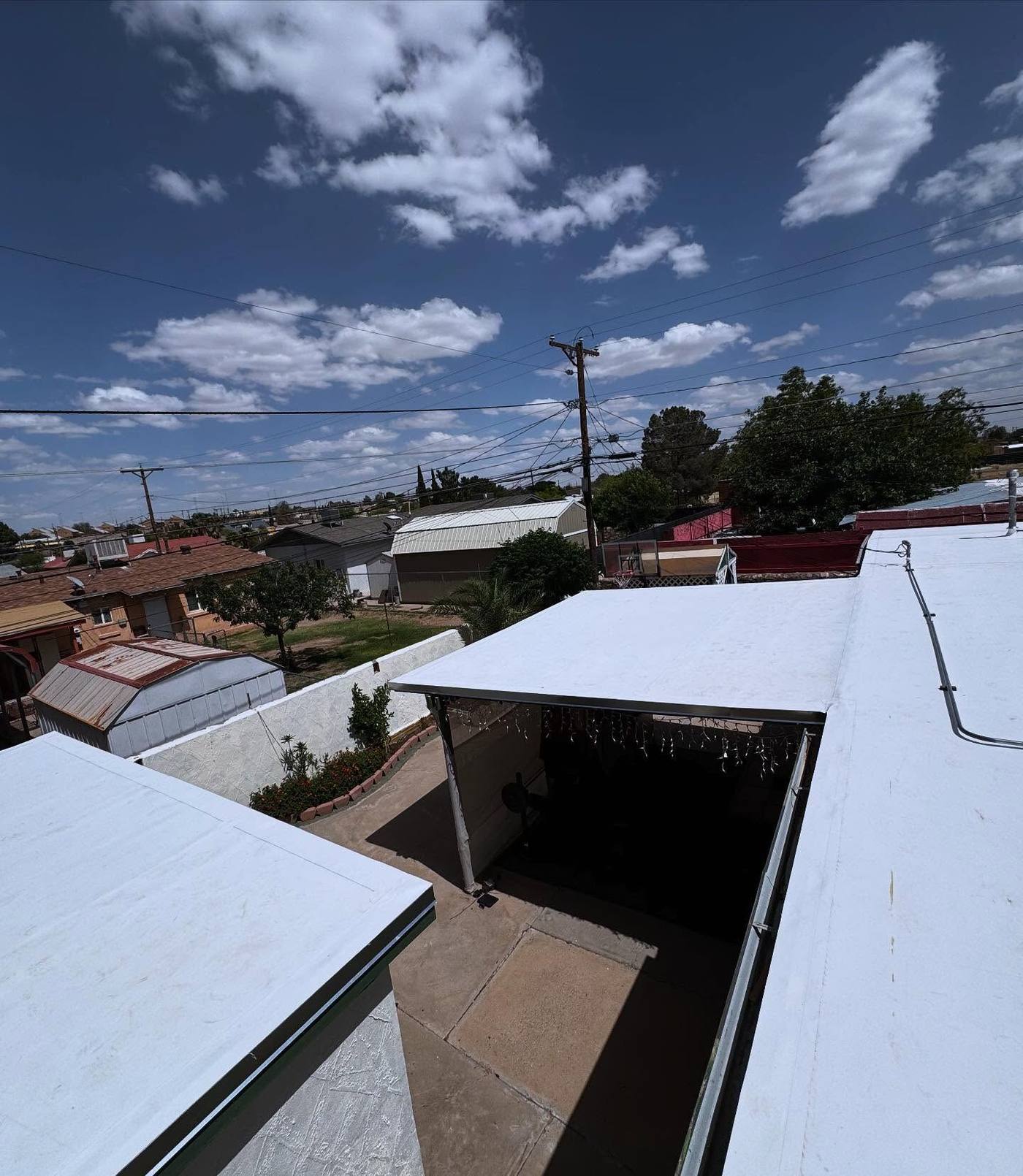 White coated flat roofs on a home and carport in El Paso